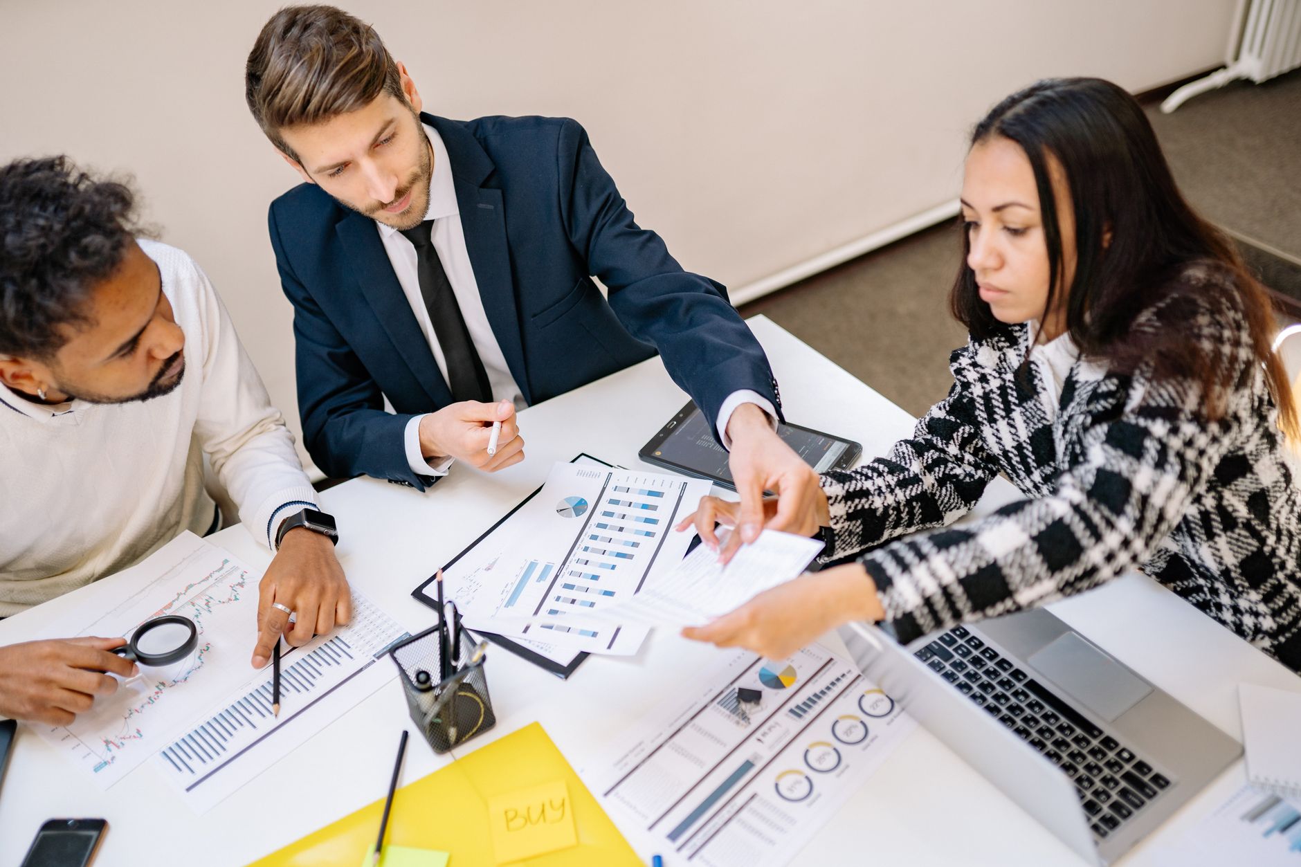 A customer success team reviewing an expansion playbook and account growth plan in a meeting