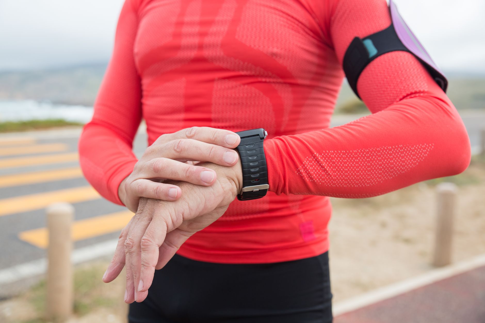 Active person jogging outdoors with a fitness tracker on their wrist, representing everyday fitness monitoring
