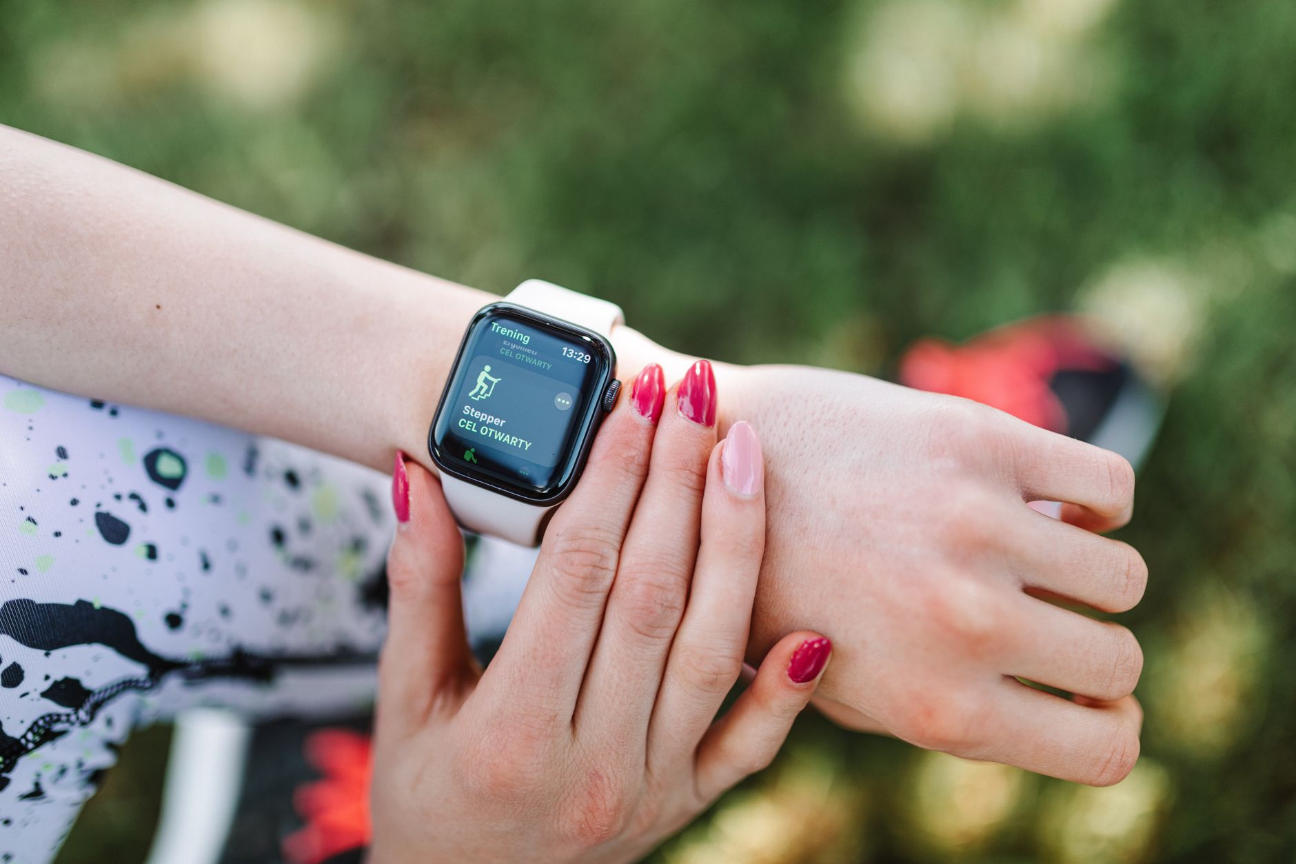 Health-conscious person checking Apple Watch health metrics including heart rate and activity rings in a modern setting